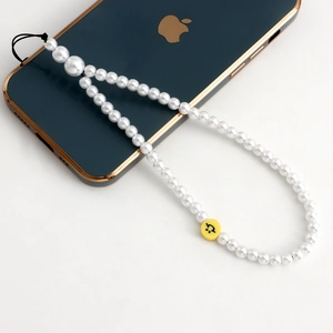 Dragonne de téléphone en perles d'imitation avec perle souriante jaune sur mobile