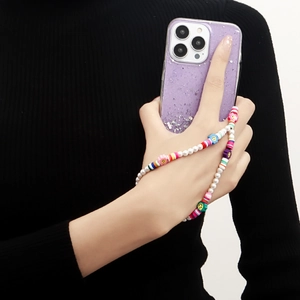 Close-up of handmade colorful beaded phone charm with pearls and purple glitter star case