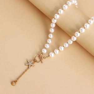 Elegant beaded shell necklace featuring rhinestone starfish pendant and golden shell charm