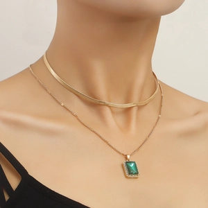 Double-layered gold snake chain necklace featuring a vintage emerald green pendant for women