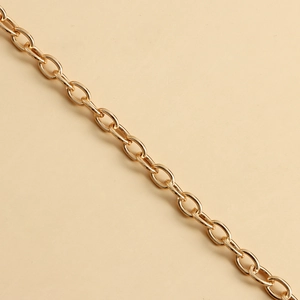 Detail of the polished golden metal chain links with a smooth finish and bright reflection