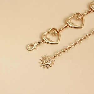 Golden heart-shaped chain belt featuring sun and moon relief charms with lobster clasp