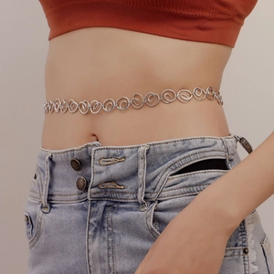 Minimalist silver spiral geometric waist chain on female model with denim jeans