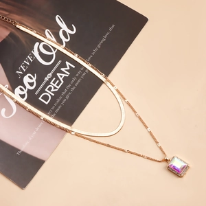 Detail view of double-layer snake chain with holographic faux gemstone pendant