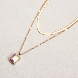 Close-up of double-layer snake chain with aurora gemstone pendant and micro-pave crystals