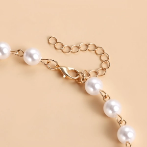 Detail of double-layer pearl necklace with golden lobster clasp and adjustable chain