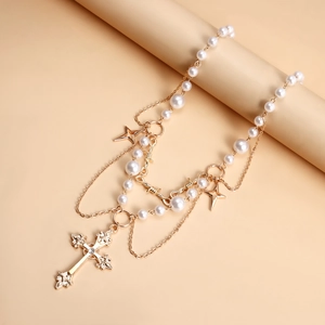 Detail of double-layer pearl necklace with golden cross and star pendants and fringe