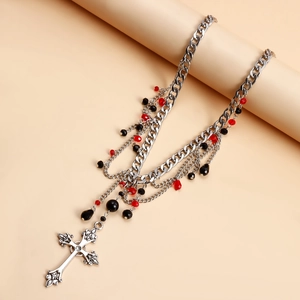 Detail of gothic multi-layer necklace with red beads and baroque cross pendant