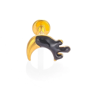 Detailed macro view of a gold-toned crescent moon labret stud with black enamel drip design