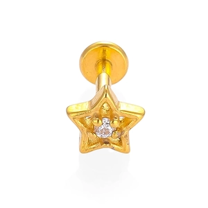 Macro detail of a 316L gold star labret stud featuring a central clear cubic zirconia stone