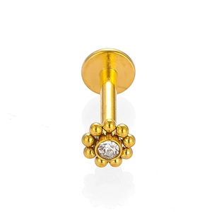 Détail macro du piercing labret fleur en acier 316L avec un zircon transparent