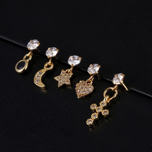 Detail of five-piece gold earring set with zircon stars, moon and cross charms