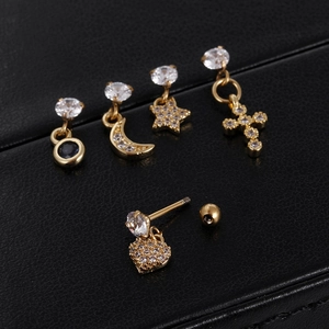 Detail of gold stainless steel stud earring set with zircon moon star and cross charms