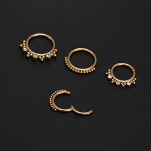Set of four gold 316L stainless steel septum rings with white stones and clicker closure