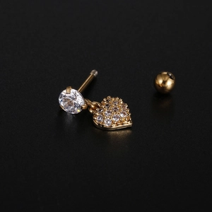 Macro detail of gold-plated spiral ball stud earring with zircon heart pendant and crystals