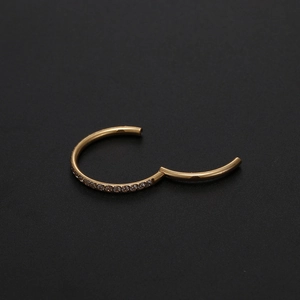 Detail of rose gold 316L stainless steel clicker ring with white zircon inlays