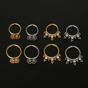 Detail view of 16G stainless steel septum rings in gold and silver with zircon stones