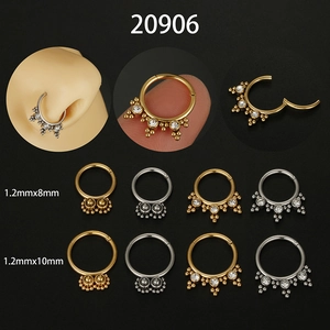 Detail view of 16G stainless steel nose rings with zircon inlay and clicker mechanism