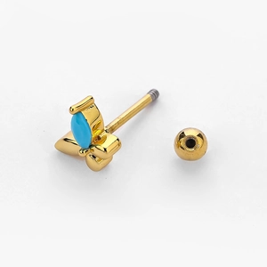 Macro detail of gold butterfly cartilage stud with blue stone and screw ball back