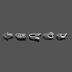 Detailed view of five silver-tone U-shaped clip-on nose rings with zircon inlays