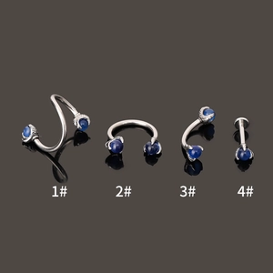 Detailed view of four 316L stainless steel piercings with blue opal stones in dragon claw settings
