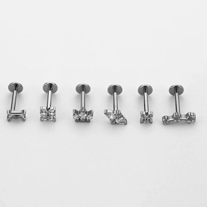 Set of six titanium labret studs with zircon inlays in crown and floral shapes