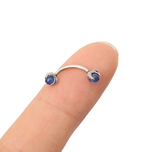 Detailed view of silver stainless steel curved barbell featuring blue opal dragon claw ends