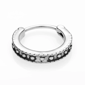Detailed macro view of vintage stainless steel clicker earring with rope texture and beads