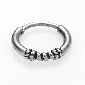 Detailed view of silver titanium steel hoop earring with twisted rope and bead patterns