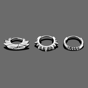 Detailed view of vintage titanium steel earrings with wing, spike, and textured designs