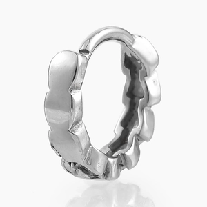 Detailed view of silver stainless steel leaf earring with wave design on white background