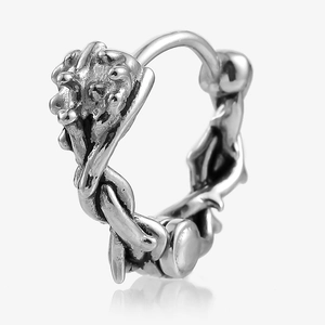 Macro detail of Gothic silver earrings with thorn-like molten metal texture and oxidized finish