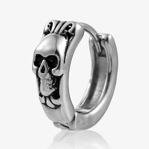Detail of gothic skull relief on silver stainless steel hoop earring with vintage finish