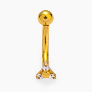 Macro detail of curved barbell eyebrow ring with gold finish and three clear zircon stones