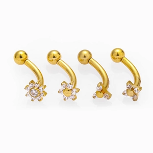Golden stainless steel curved barbell set with flower and star-shaped zircon inlays