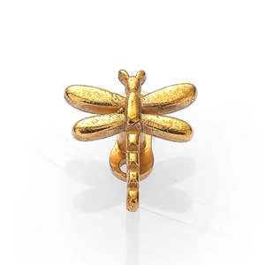 Detailed close-up of a golden dragonfly-shaped 316L stainless steel body piercing stud