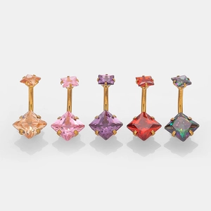 Close-up of five colorful square zircon belly rings with gold-plated stainless steel bars