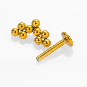 Piercing labret de acero 316L dorado con diseño de racimo de bolas y base plana lisa