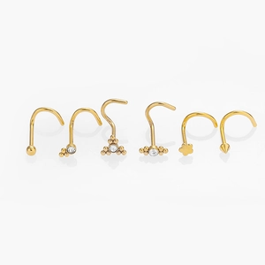 Detail of 6-piece golden nose stud set with crystal flower and round ball designs