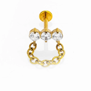 Piercing de labio en acero 316L dorado con tres cristales blancos y una cadena delicada