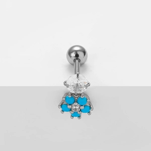 Detail of curved stainless steel navel ring with blue flower petals and zircon stones