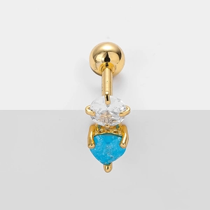 Detail of gold belly button ring with round white zirconia and blue heart gemstone