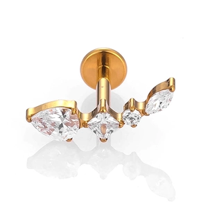 Detail view of gold titanium labret stud with micro-paved zircons and flat back design