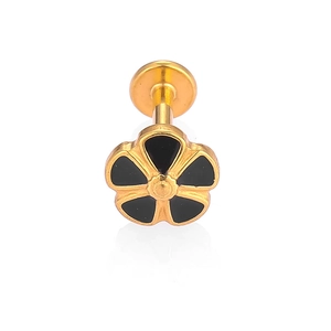 Macro shot of 316L gold stainless steel lip stud featuring a black flower design