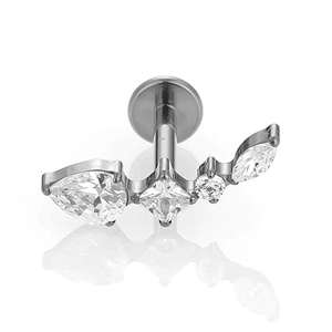 Macro detail of F136 titanium labret stud with teardrop and square zircon stones