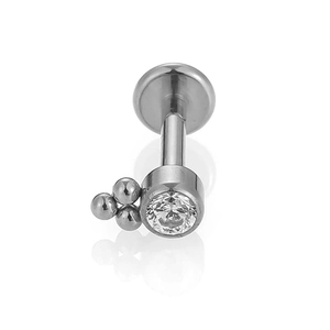 Macro detail of F136 titanium labret stud with cubic zirconia and metal bead decor