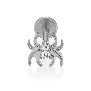 Detailed close-up of a spider-shaped F136 titanium stud with sparkling cubic zirconia gems