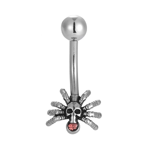 Detail view of spider belly button ring with skull head and red gemstone inlay