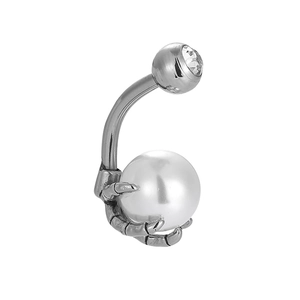 Detail of 316L stainless steel navel ring with skull hand holding a large white pearl