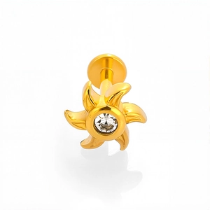 Macro view of gold 316L stainless steel lip stud with starburst design and clear gem
